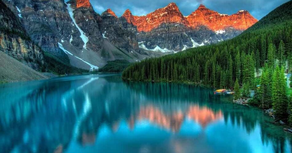 Turquoise Moraine Lake with sunrise-lit peaks in Banff National Park, Canada
