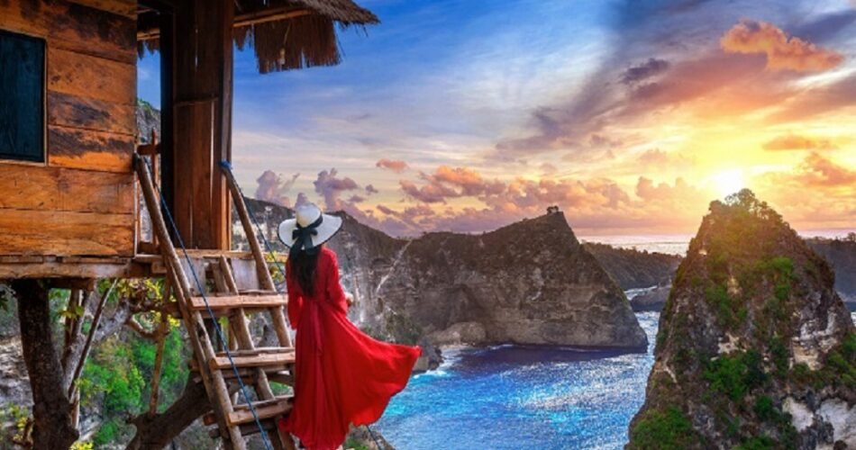 Woman embracing the sunrise in the mountains, symbolizing a new beginning after heartbreak