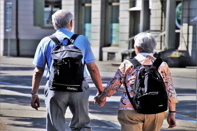 Senior couple walking outdoors – slow travel tips and wellness journeys for couples in their 50s and beyond.
