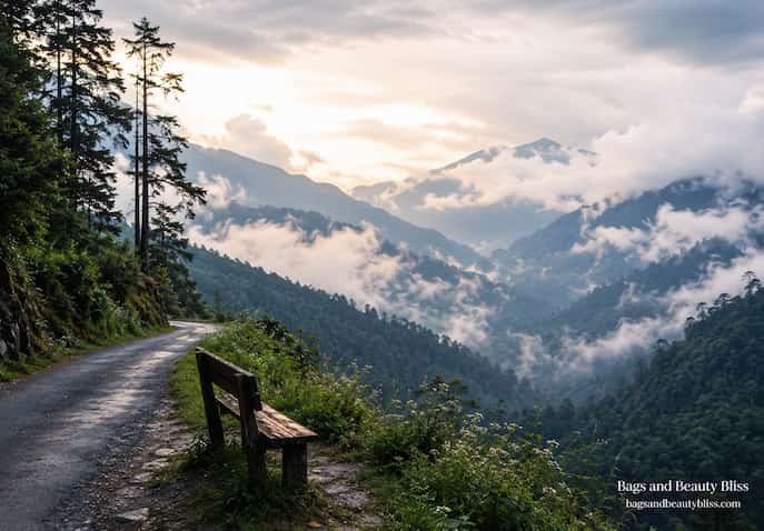  A quiet mountain road and wooden bench overlooking mist-covered Himalayan valleys in Sikkim, India, creating a peaceful setting for reflection, emotional healing, and mental calm.